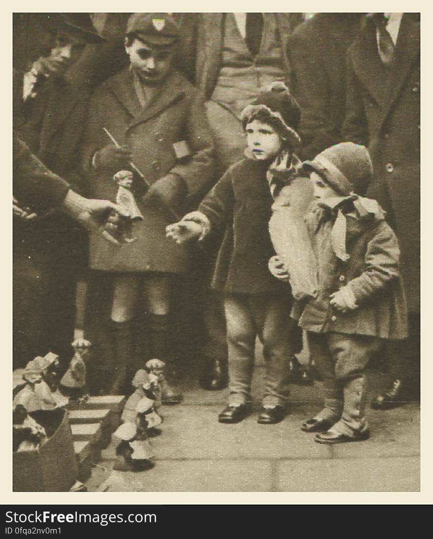 London, 1920s Photogravure by Donald Macleish from Wonderful London by St John Adcock, 1927. From the section entitled Some of the sights and sounds that liven London streets: Curb-side hawkers are to be found wherever shoppers congregate, but Holborn at Christmas is a favourite pitch of theirs. With their nodding-dolls and acrobatic toys - mechanisms that never appear to function so deftly after purchase - they are often a greater joy to children than all the expensively garnished shop-windows on the other side of the pavement.