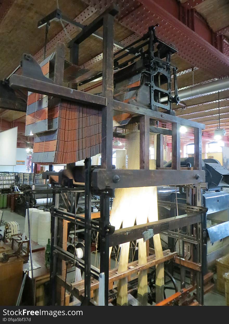 A ribbon loom. Programmable using punch cards and used for complex designs such as labels. A ribbon loom. Programmable using punch cards and used for complex designs such as labels.