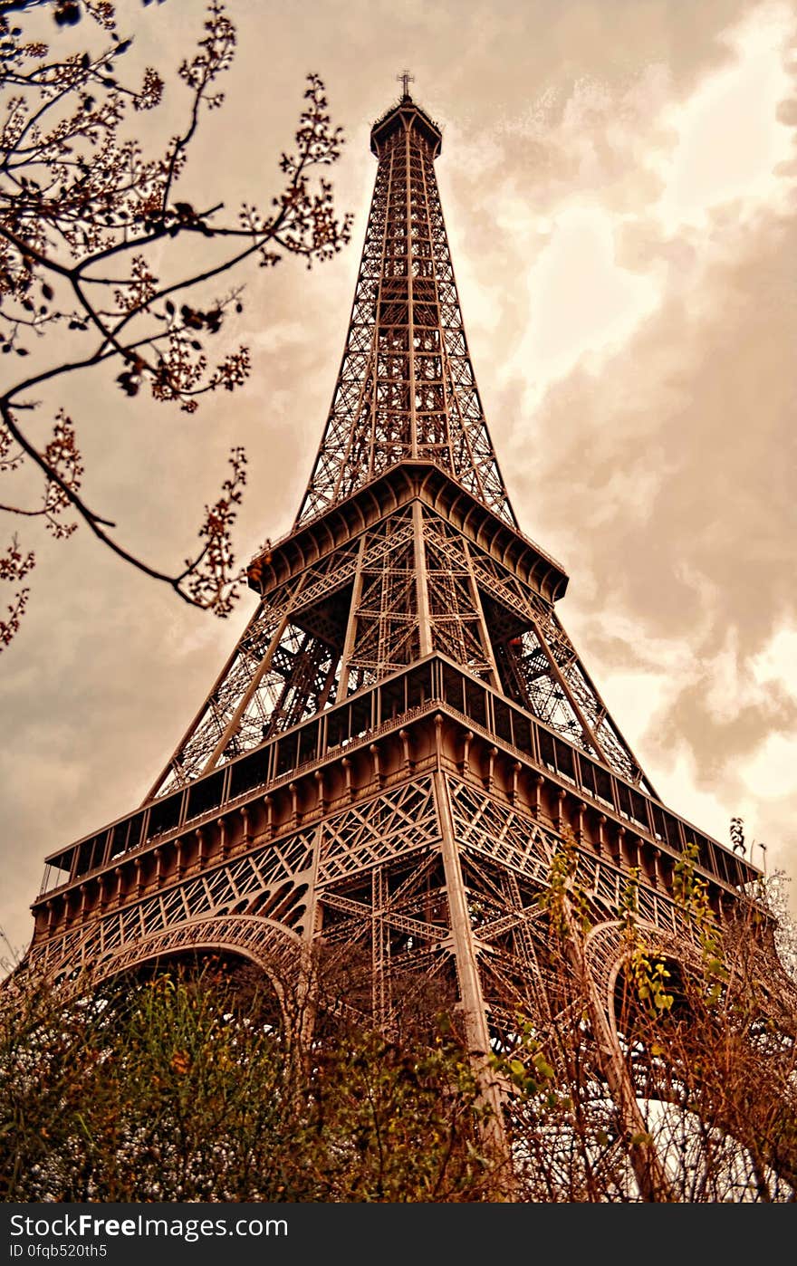 Low angle sepia view looking to top of Eiffel tower in Paris, France.