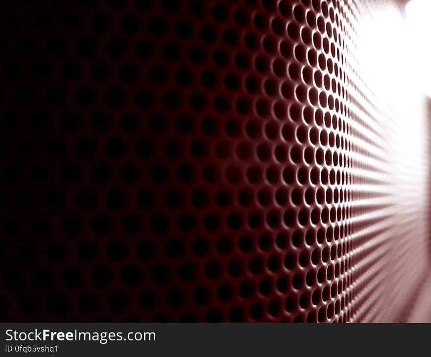 An abstract background with grill with small round holes.