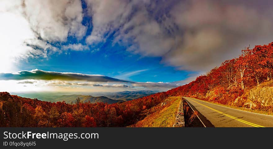 Scenic View of Mountain Road Against Cloudy Sky