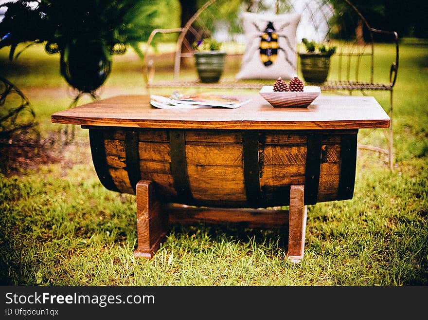 A rustic wooden garden table on a lawn. A rustic wooden garden table on a lawn.