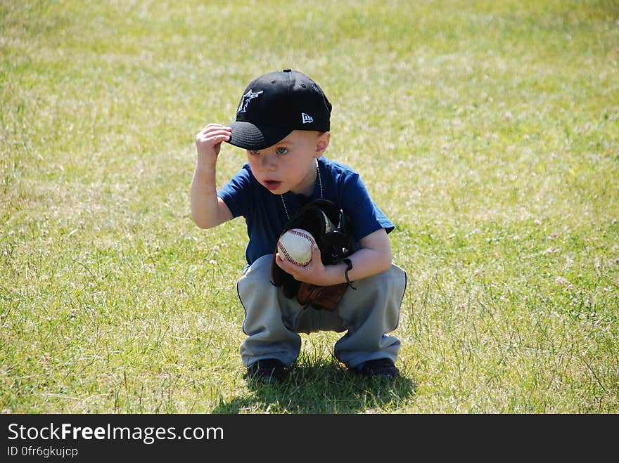 Boy in Blue Crew Neck T Shirt on Green Grass during Daytime