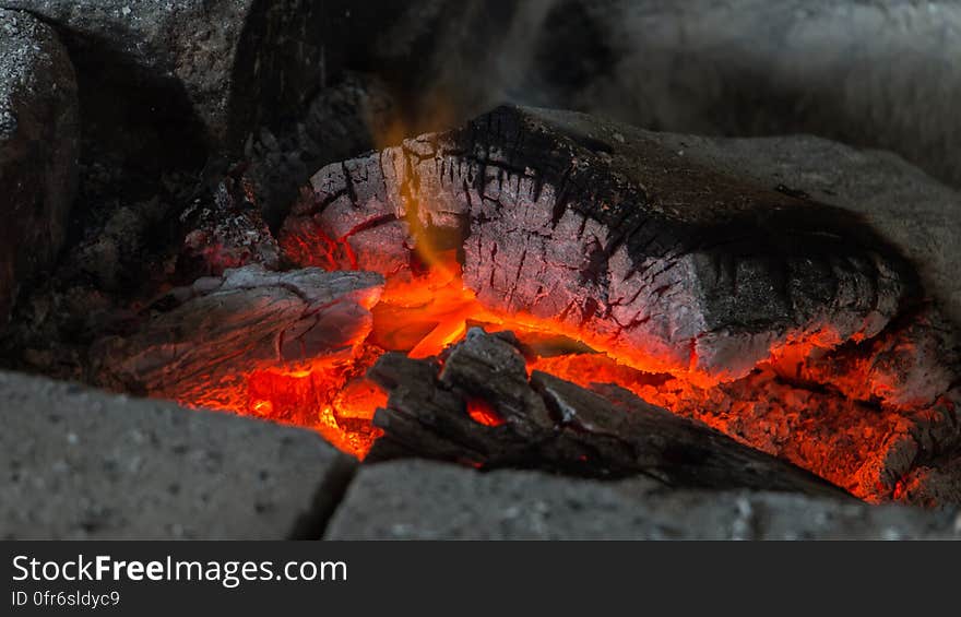 A fireplace with burning coals and cinders.