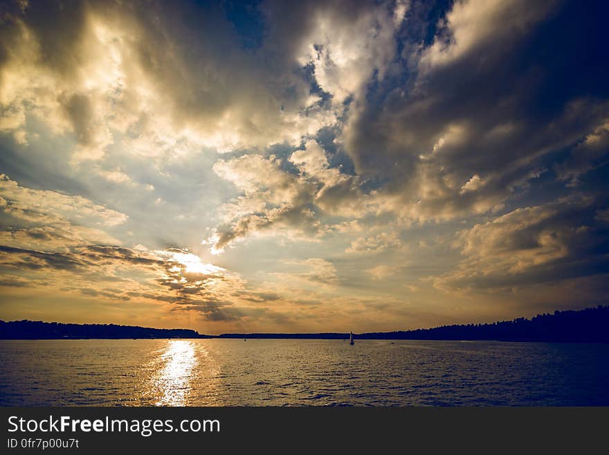 A sunset over the sea with dark cloudy skies. A sunset over the sea with dark cloudy skies.