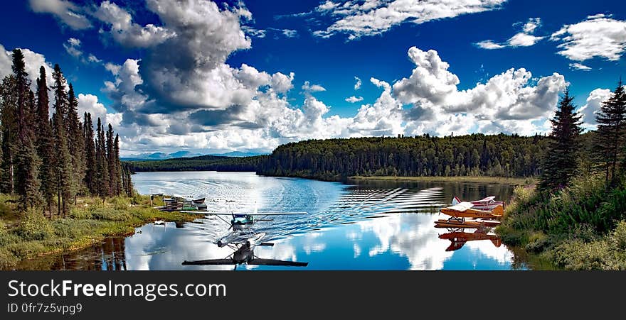 A floatplane landing on a lake in the wilderness. A floatplane landing on a lake in the wilderness.