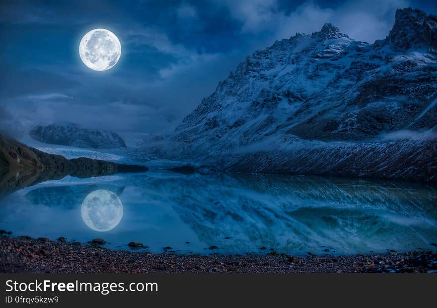 Full Moon Near Snowcap Mountain