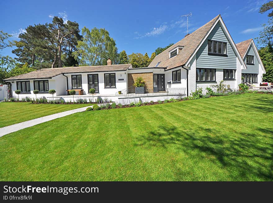 A luxury home and green lawn around it.