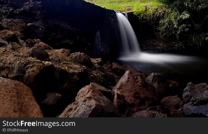 Waterfalls With Rocks in the Middle of Forest