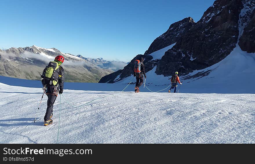 Man Walking on Snow Covered Mountain