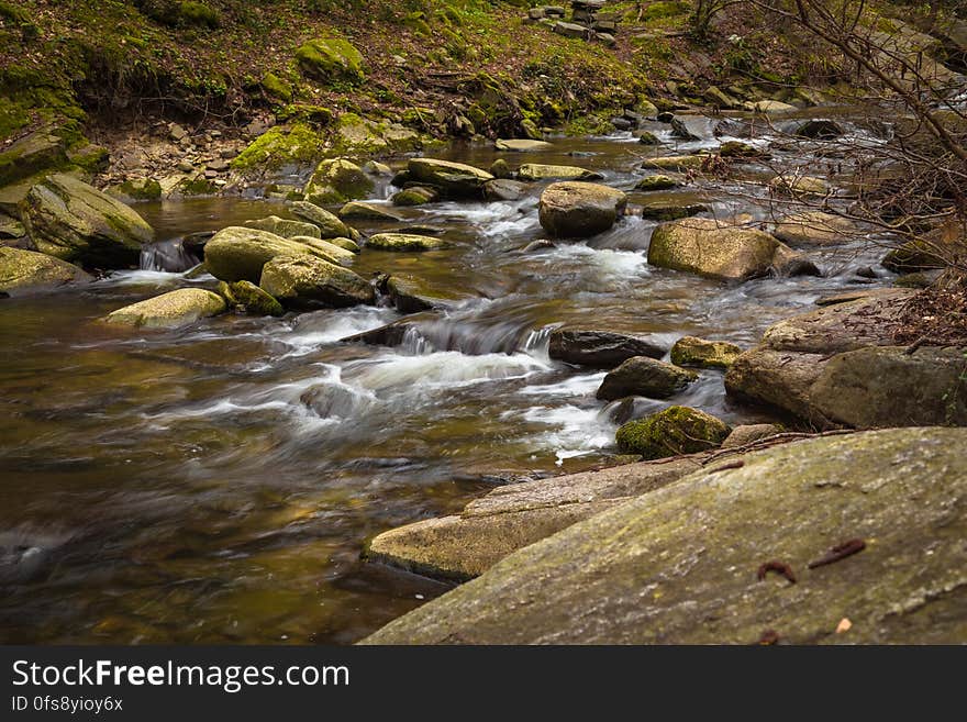 A river passing through a rocky stream. A river passing through a rocky stream.