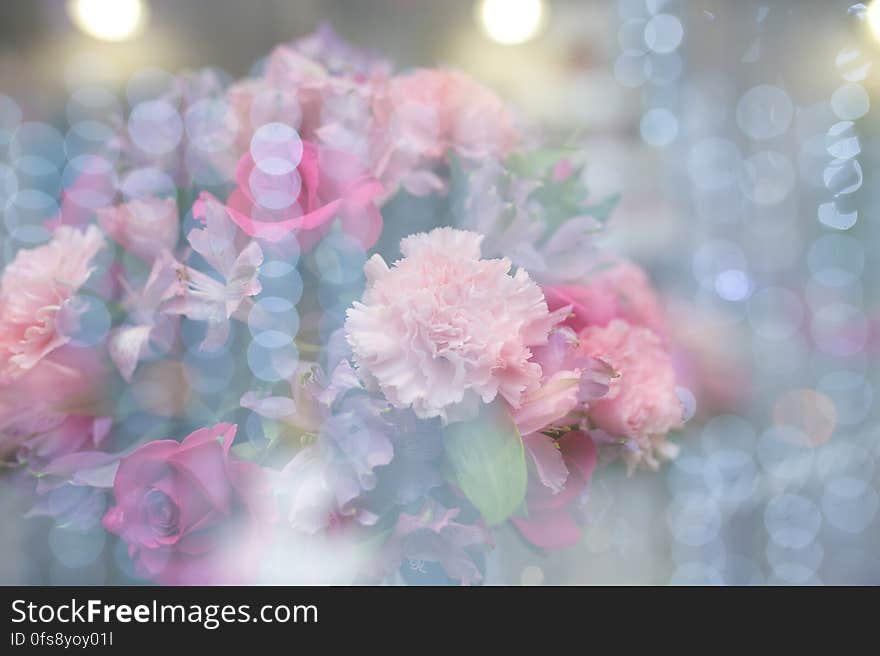 A flower arrangement with bokeh lights on top.