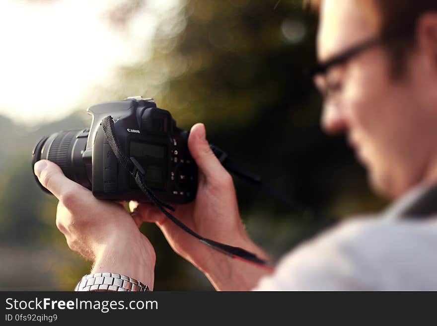 Person Holding Camera during Day Time