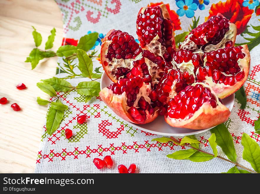 Still life with pomegranate on a plate. Still life with pomegranate on a plate