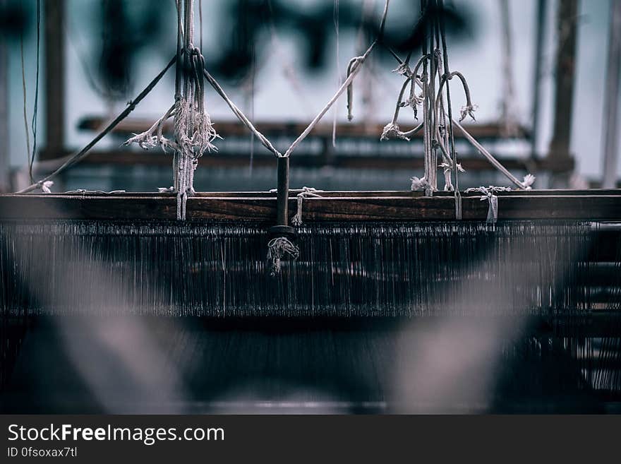 A view inside a loom used in weaving fabrics. A view inside a loom used in weaving fabrics.