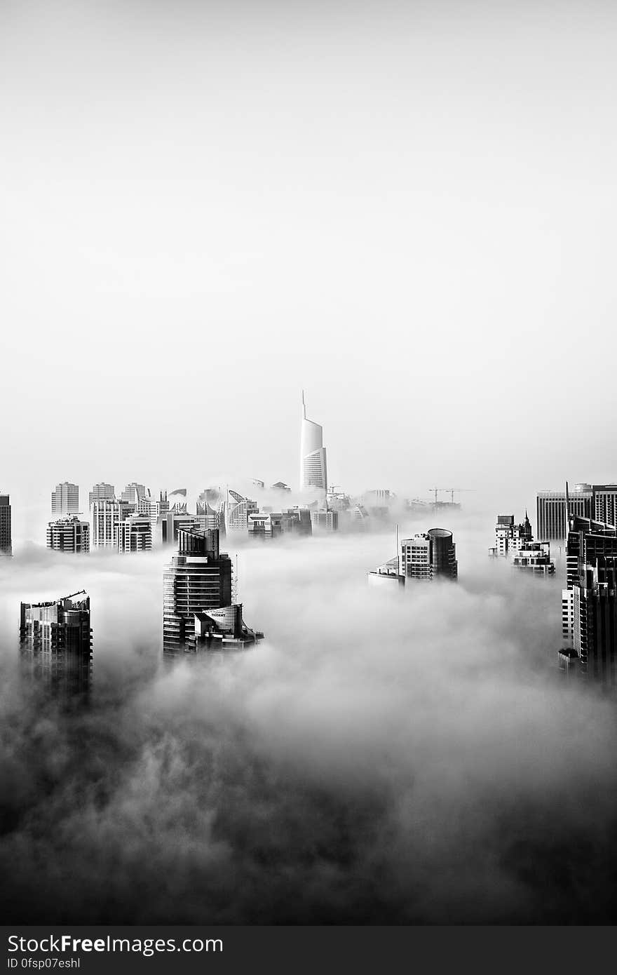 A black and white photo of the city of Dubai covered in clouds. A black and white photo of the city of Dubai covered in clouds.