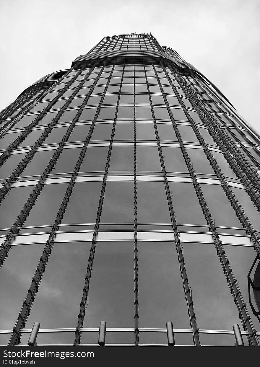 A low-angle view of a skyscraper in black and white. A low-angle view of a skyscraper in black and white.