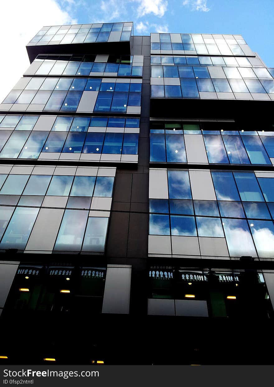 A low angle view of a glass skyscraper.