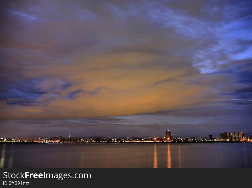 City Light Reflecting on Calm Waters Night Time