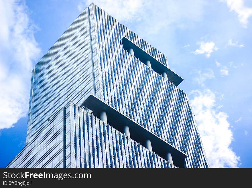 Facade of modern steel and glass building against blue skies on sunny day. Facade of modern steel and glass building against blue skies on sunny day.