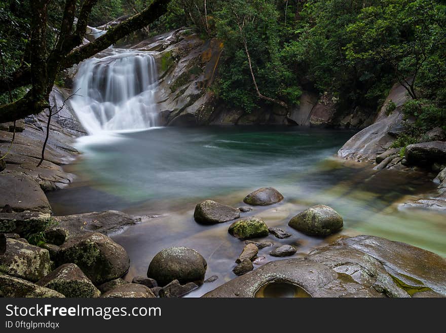 A cascade and rocky stream in tropical forest. A cascade and rocky stream in tropical forest.