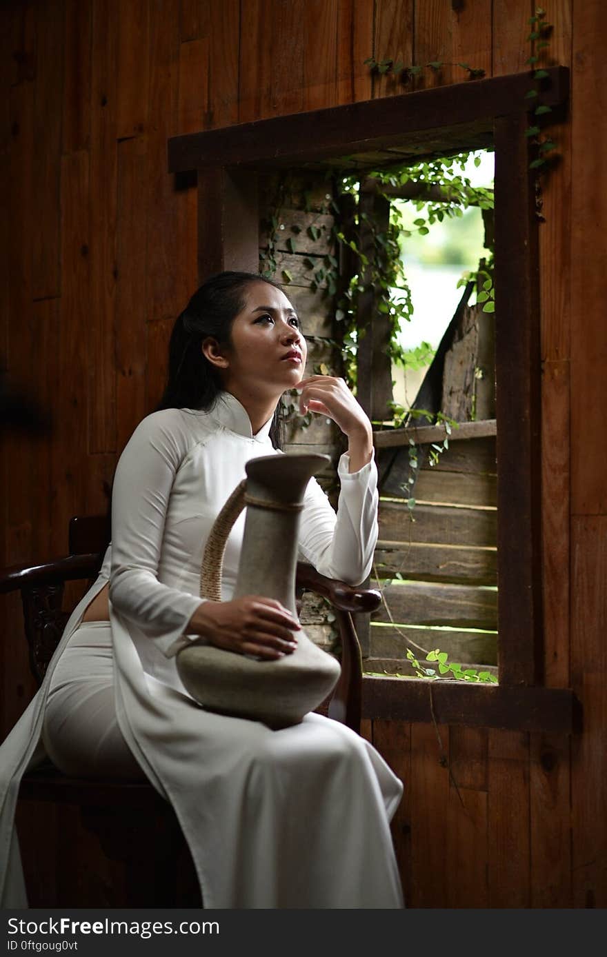 Woman Wearing Traditional Clothes Holding A Jar