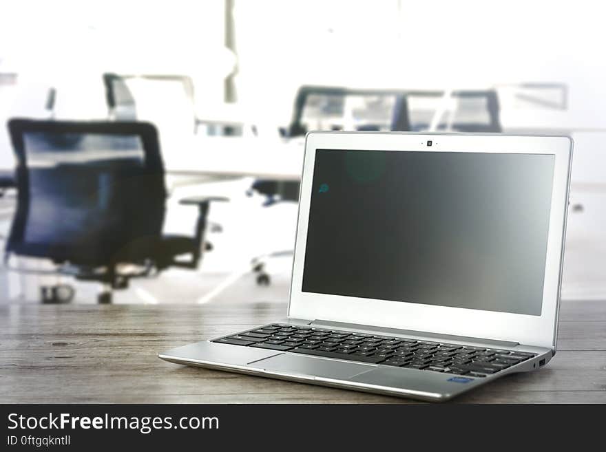 A laptop on the desk in office setting. A laptop on the desk in office setting.