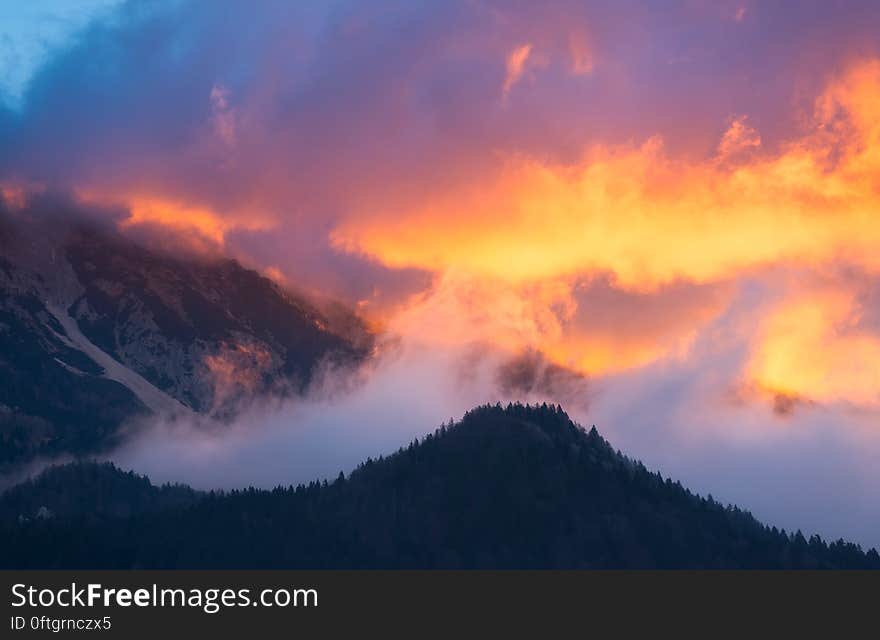 A view of mountains and clouds with burning skies. A view of mountains and clouds with burning skies.