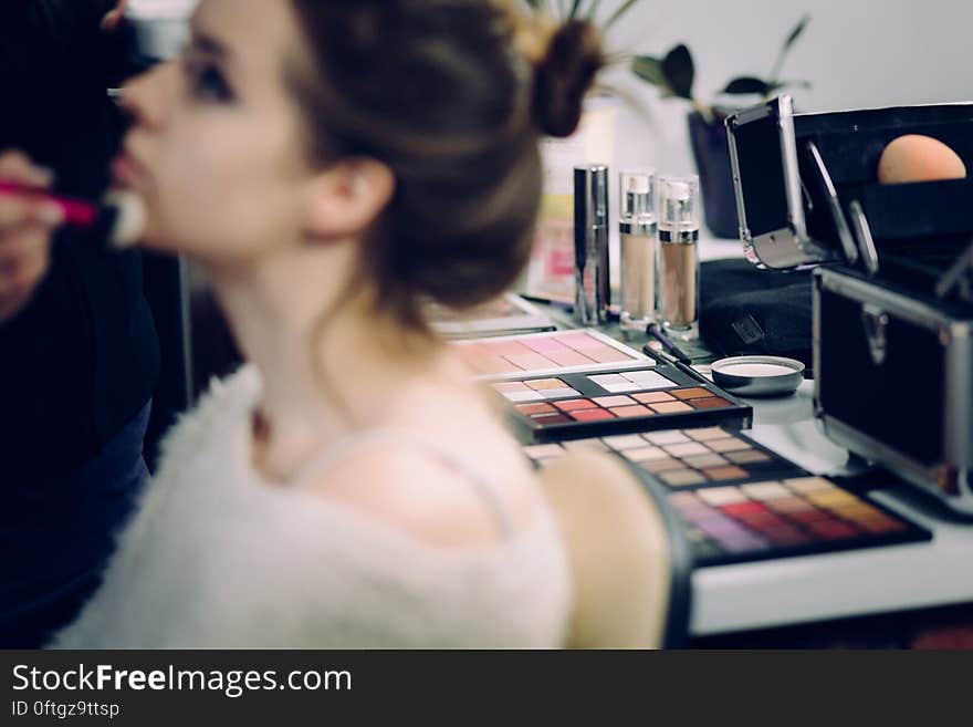 A make-up artist applying make-up on a woman. A make-up artist applying make-up on a woman.