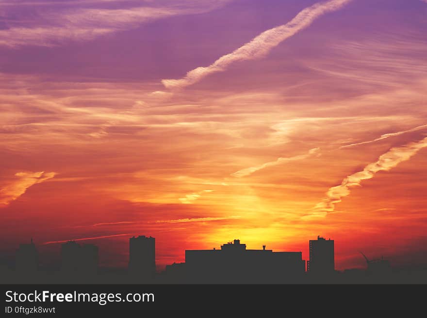 A view of a city skyline at sunset.