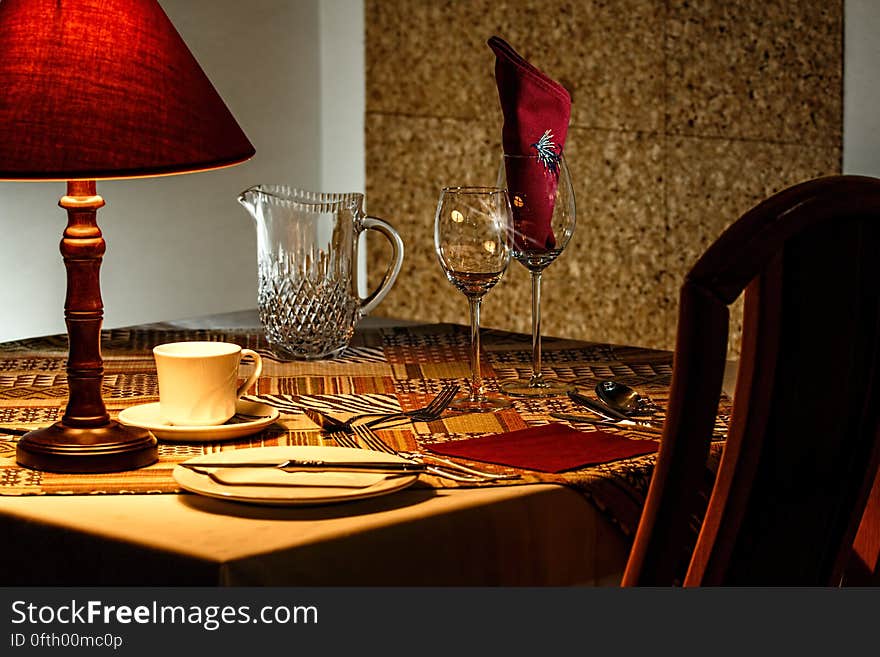 Brown and Red Table Lamp Near White Ceramic Mug