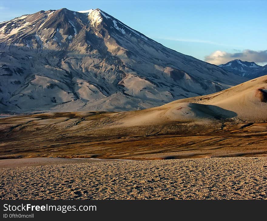 Photo of White Grey Mountain Beside Two Tone Brown Mountain during Daytime