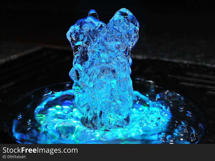 A fountain with blue lights bubbling. A fountain with blue lights bubbling.