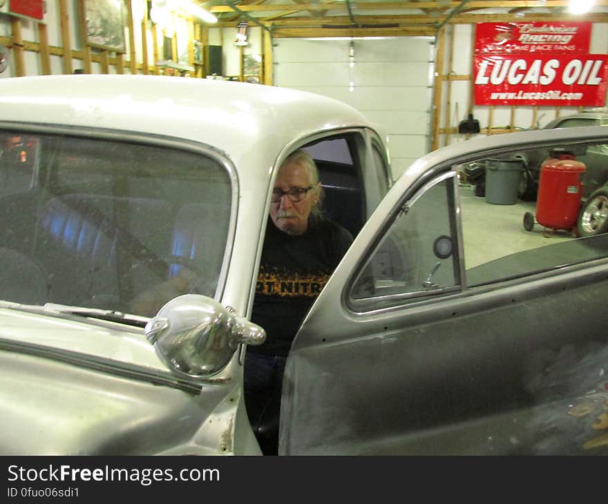 Dad sitting in the Mercury, wanted me to listen to the engine. Dad sitting in the Mercury, wanted me to listen to the engine.