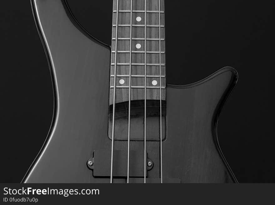 Close Up Photo of Gray Electric Bass Guitar