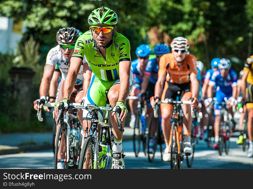 A group of bikers on street during a race. A group of bikers on street during a race.