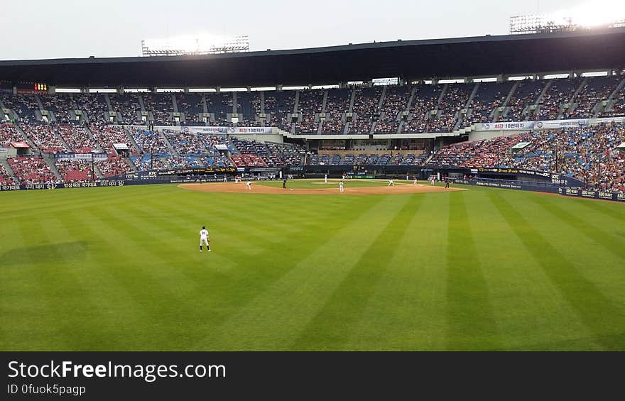 Players on stadium diamond during professional baseball game.