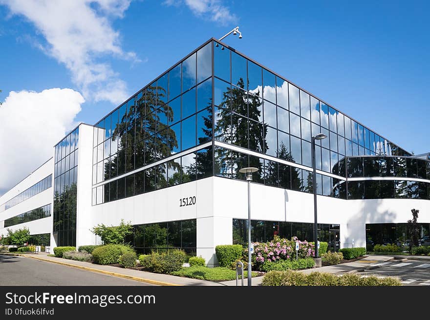 A modern office building with glass panels.