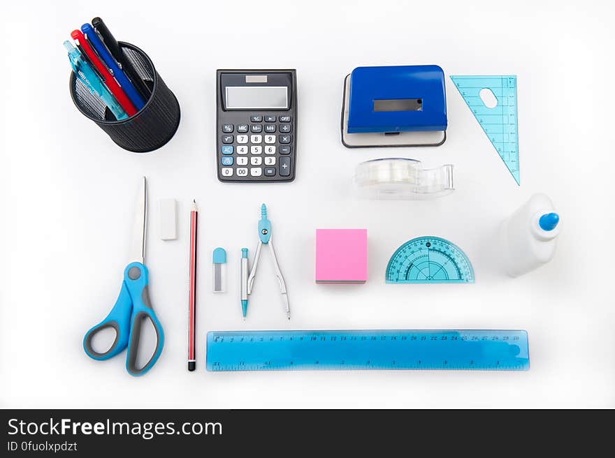 A desk with office supplies and drawing tools.