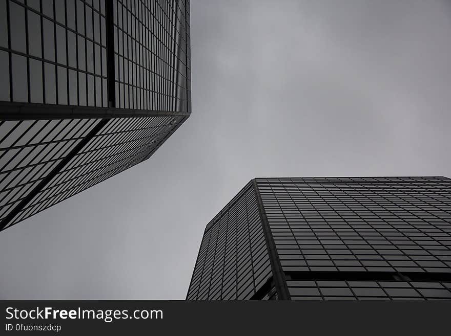 A pair of modern skyscrapers with sky between them.