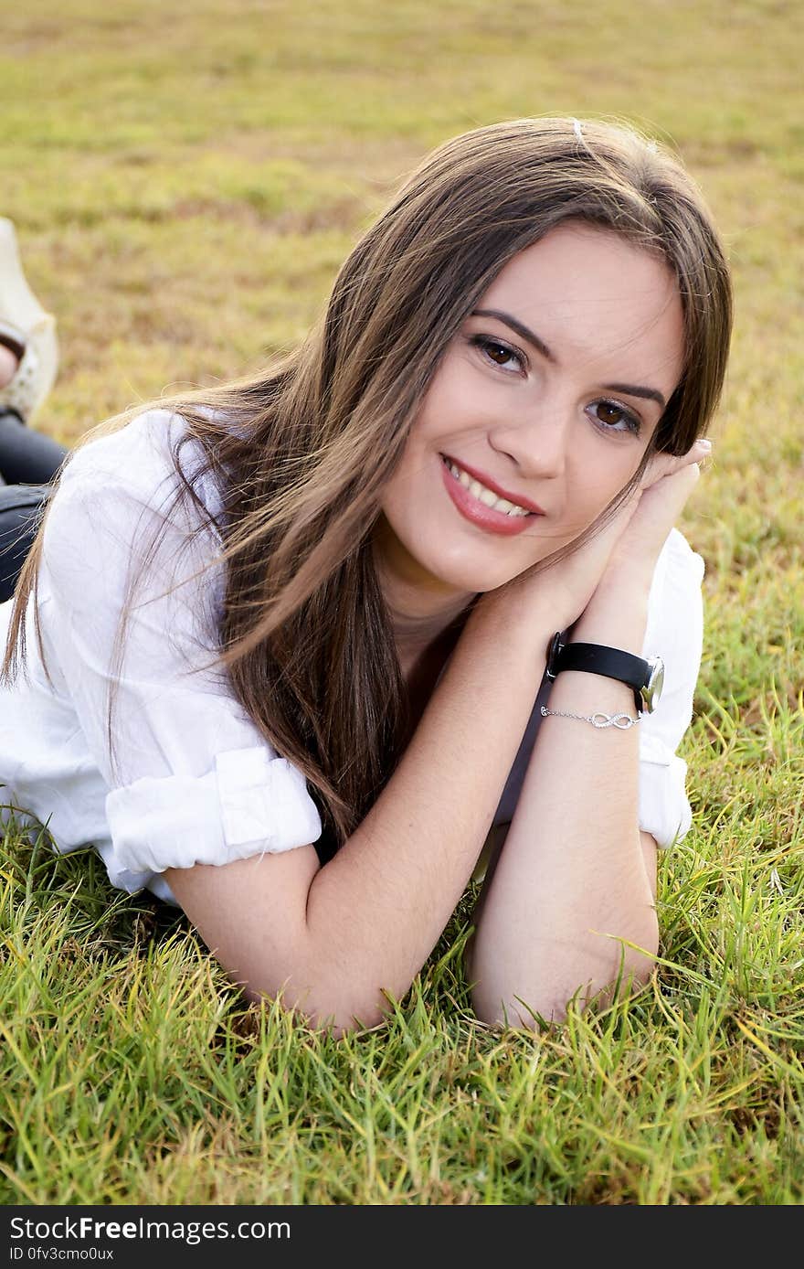 Portrait of Young Woman Lying on Grass