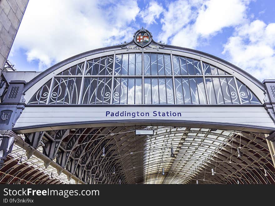 Entryway to Paddington Station railroad in London, England against blue skies on sunny day. Entryway to Paddington Station railroad in London, England against blue skies on sunny day.