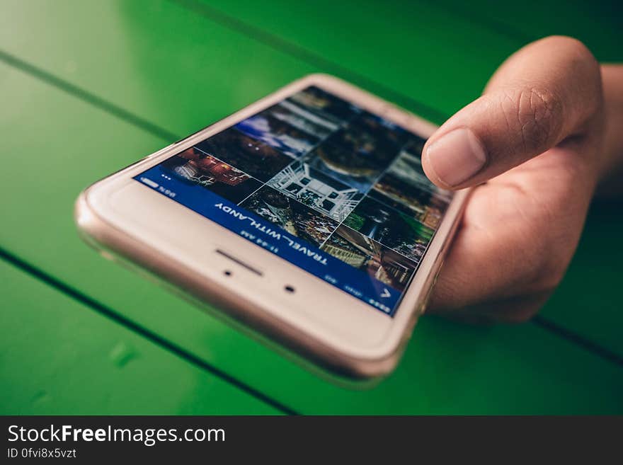 A close up of a hand holding a smartphone. A close up of a hand holding a smartphone.