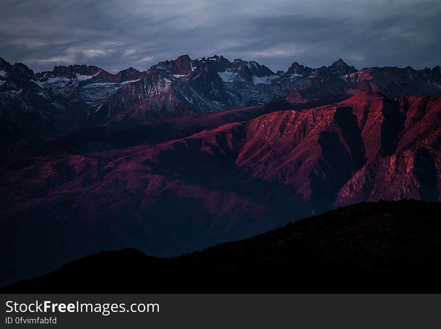 A mountain landscape with sun setting. A mountain landscape with sun setting.