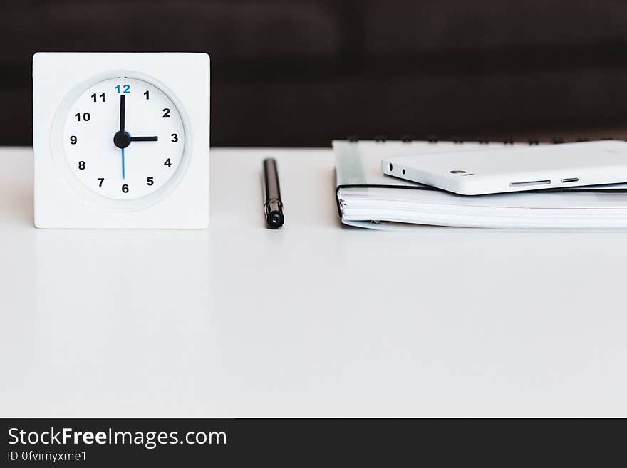 Business still life with clock, pen, notebook and cell phone on desktop. Business still life with clock, pen, notebook and cell phone on desktop.