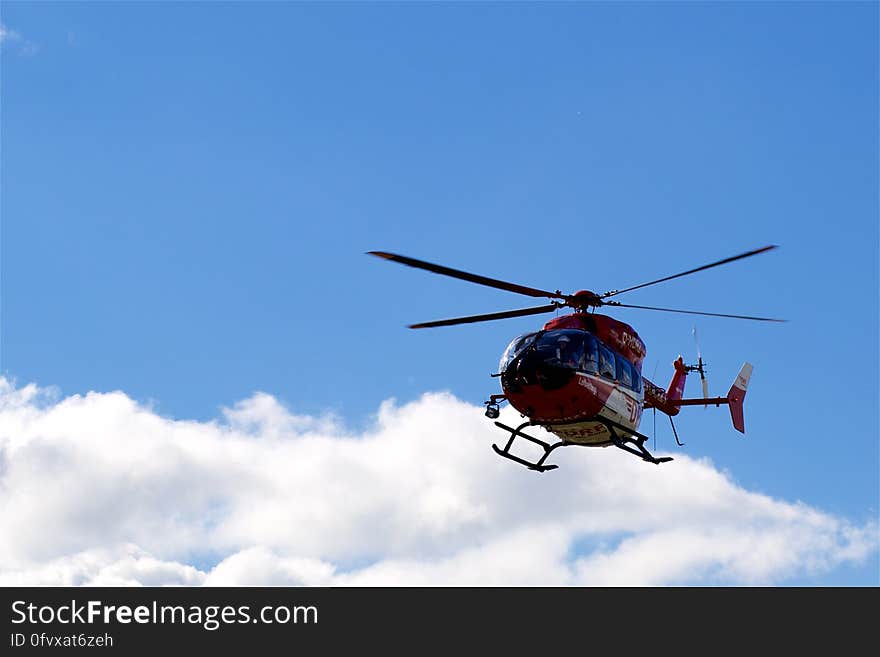 Helicopter flying in blue sky with cloudscape. Helicopter flying in blue sky with cloudscape.