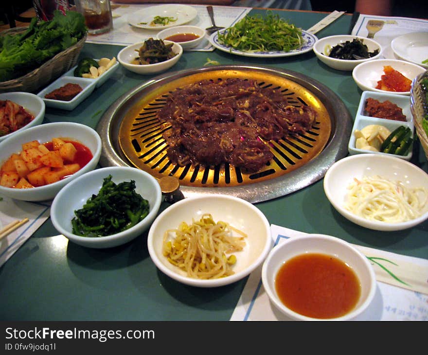 Many sides wait in anticipation while the meat begins to cook. Hae Woon Dae