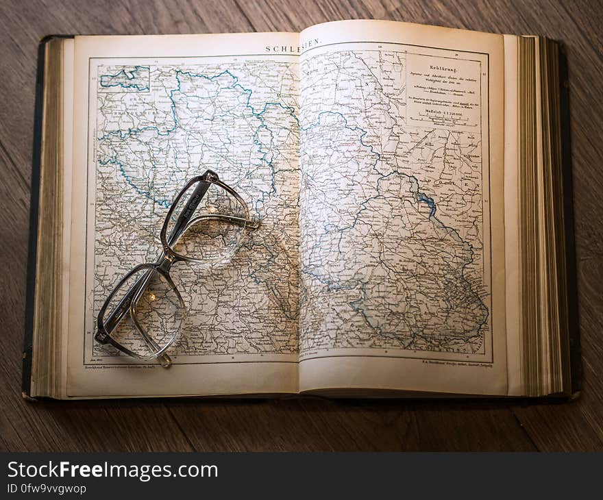 Black Framed Eyeglasses Map in Book