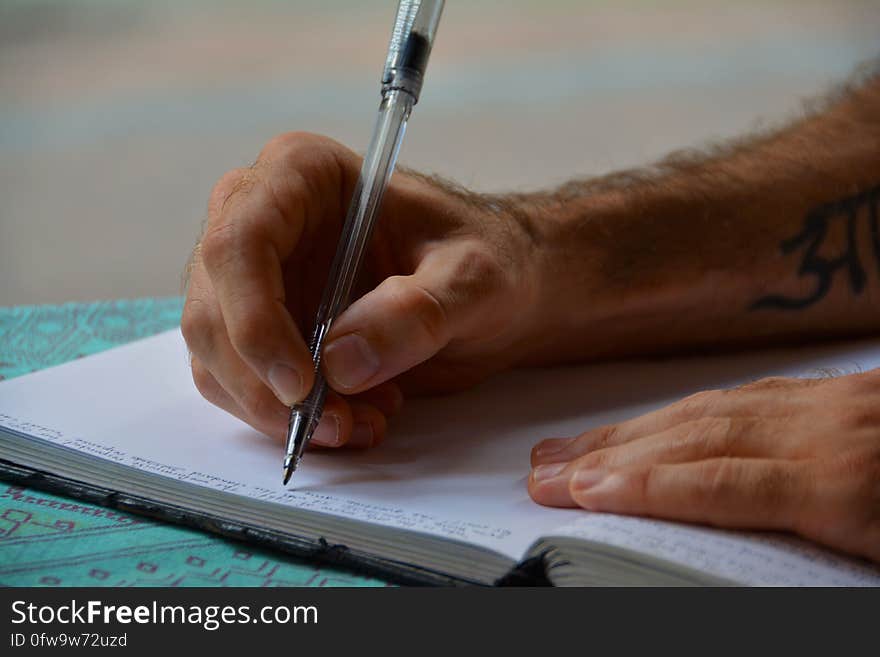 Man Writing in a Book