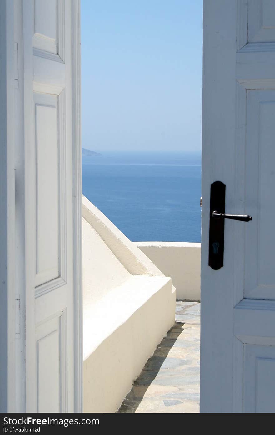 A door leading to a terrace with an ocean view. A door leading to a terrace with an ocean view.